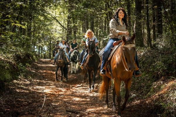 Horseback riders on a wooded trail at Bogue Chitto State Park